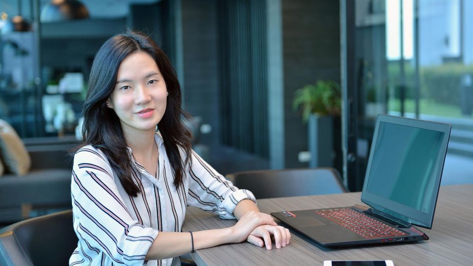 Casual Business Asian Woman Smiling In Front Of A Laptop In Condo